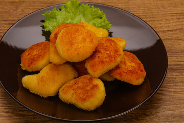 Fried chicken nuggets served salad leaves