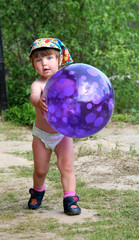 little girl playing with a ball