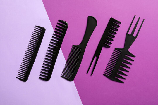 Set of black combs on color background, flat lay