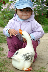 a small child with a goose