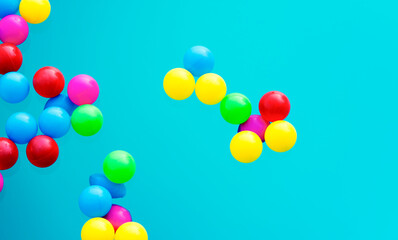 Multi colored balls levitation in mid air on blue background.