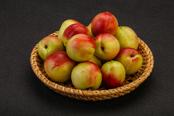 Sweet small nectarines in the basket