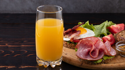 orange juice and snacks on wood background with copy space