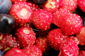 Macro shot of fresh blueberries and strawberries salad.