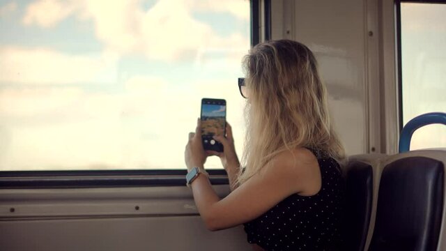 Woman Tourist Looking On City And Taking Photo On Mobile Phone Camera.Tourist Active Lifestyle On Vacation Travel Tourism Adventure And Picture.Female Traveler On Train Using Smartphone App For Photo.