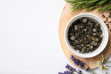 Flat lay composition with healing herbs on white wooden table. Space for text