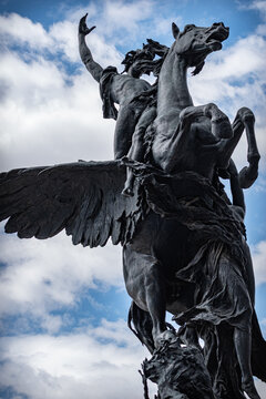 statue of a Man riding a Pegasus under blue sky
