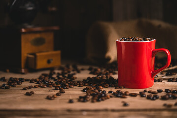 Cup of coffee beans on table