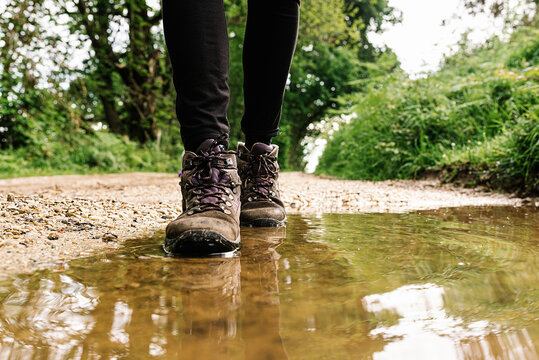 Cropped Unrecognizable Person Playing In Mud Puddle While Making Splashes