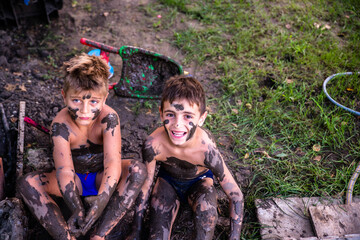  A happy little boys in the mud