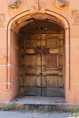 Fototapeta na wymiar Old wooden door to mausoleum at Denver's historic Riverside Cemetery