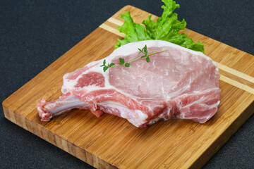 Raw pork bone steak over wooden