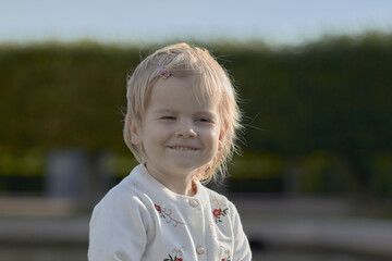 little blonde girl model in the summer in the Park