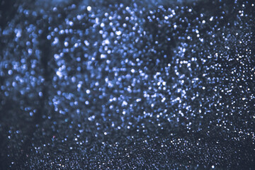 Naklejka na ściany i meble Macro photography with defocused shimmering glitter fabric in blue shade for Christmas greeting card. Sparkle background with shiny blur effect. Festive abstract glitter bokeh background.