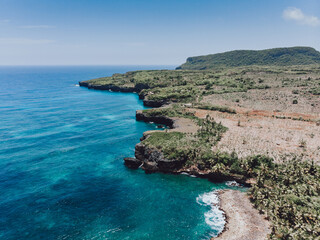 Fototapeta premium Aerial drone view of rocky shore of the Atlantic ocean with blue water lagoon in Las Galeras, Samana, Dominican Republic 