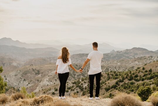 Young couple in love enjoying in mountains