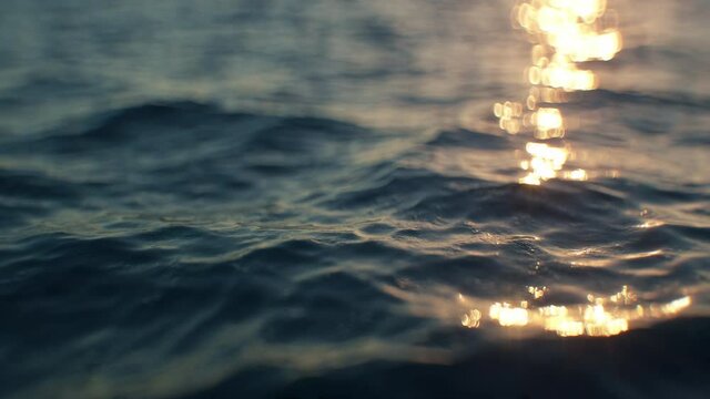 Calm sea surface close-up in slow motion in the evening. Highly detailed very realistic top quality 3d animation