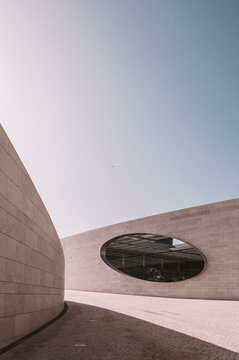 Building of Champalimaud Foundation in futuristic style with stone exterior and oval window in Lisbon