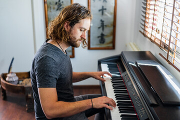 Talented man playing piano at home