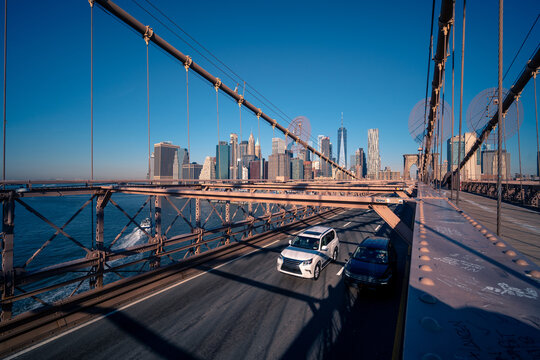 Fototapeta Suspension bridge with moving cars in city