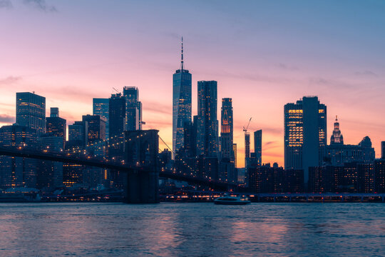 Illuminated bridge over river in night city