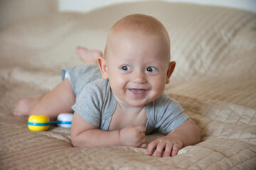 Toddler 6 months lies on his tummy and shows emotions