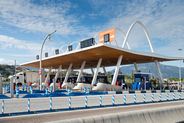 Futuristic exterior of toll road with contemporary payment system on background of blue sky