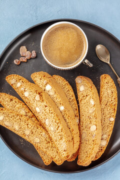 Cantucci, traditional Italian almond biscuits, with a cup of coffee, top shot