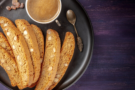 Biscotti, traditional Italian almond biscuits, with a cup of coffee, shot from above with copy space