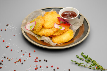 Grilled chicken fillet. Chicken nuggets with sauce on a white plate.