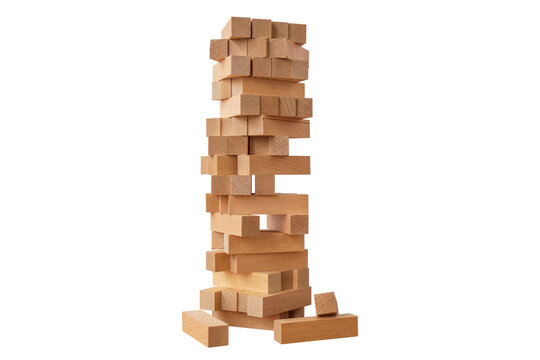 Board game Jenga Tower made of wooden blocks. A tower of unevenly shifted wooden beams. A lesson for agility, logic and coordination. Home entertainment. Balance. Close-up. Isolation, white background