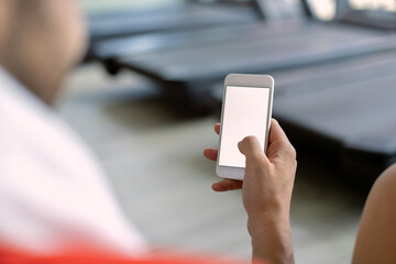 Close-up of sportsman using smart phone in health club.