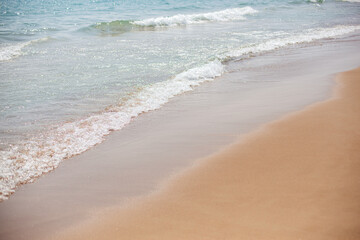 Sea foam waves are coming to the shore. Beautiful sea coast.