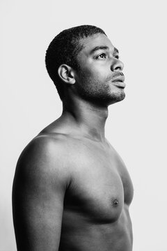 Portrait of african american man over white background and looking at camera