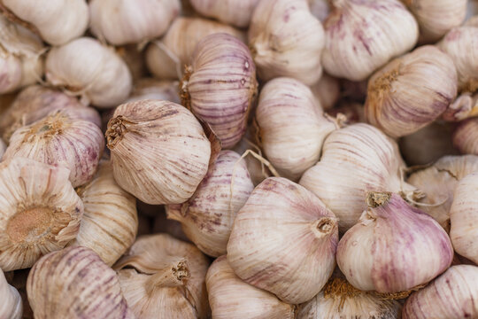 High angle of heap of raw garlic in grocery market