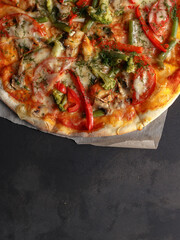 pizza on a black background, look from above. traditional dish of Italian cuisine
