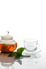 A Cup of tea with a mint branch on a white background.