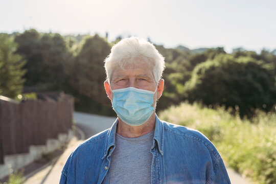Senior man with protective mask outdoors