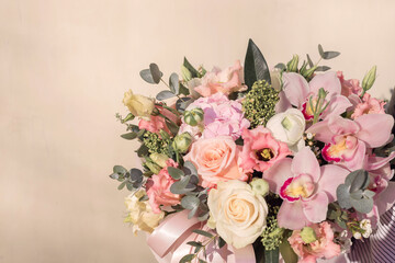 beautiful tender flowers bouquet of cream roses and pink orchids and white anemone flowers in hands...