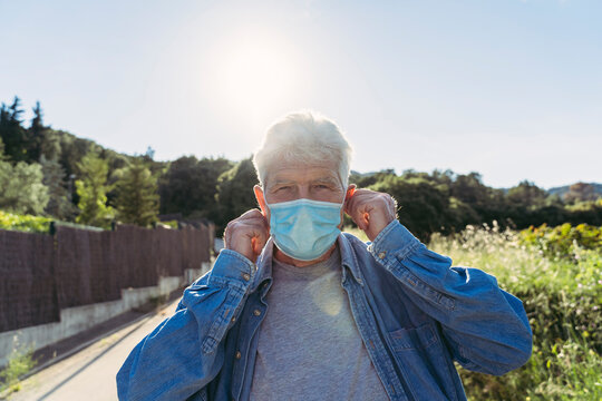 Senior man with protective mask outdoors