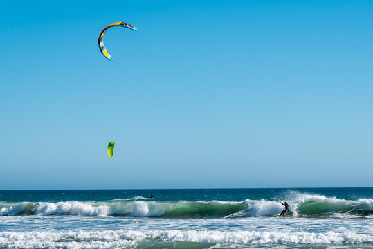 Two kite surfing in the sea