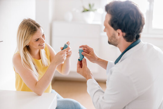Doctor explaining using of asthma inhaler