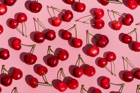 Fresh cherries on pink background
