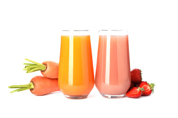 Glasses of delicious juices, fresh strawberries and carrots on white background