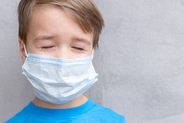 Portrait of Toddler kid wearing medical mask.A boy wearing mouth mask against air smog pollution. Concept of coronavirus quarantine or covid-19.Protection against virus and infection control concept