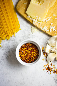 Chilli seeds, grana cheese, garlic and spaghetti
