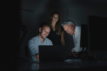 Team of business people working late in office, disussing solutions