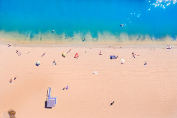 Aerial Top Drone view of a people on the Sand beach. Sea Resort Concept. Azure Beach River water and People.