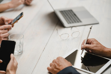 Business people working in office using portable devices, close up