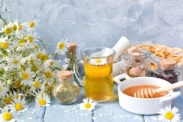 Dried and fresh herbs, flowers and medicinal tea and honey on a wooden table